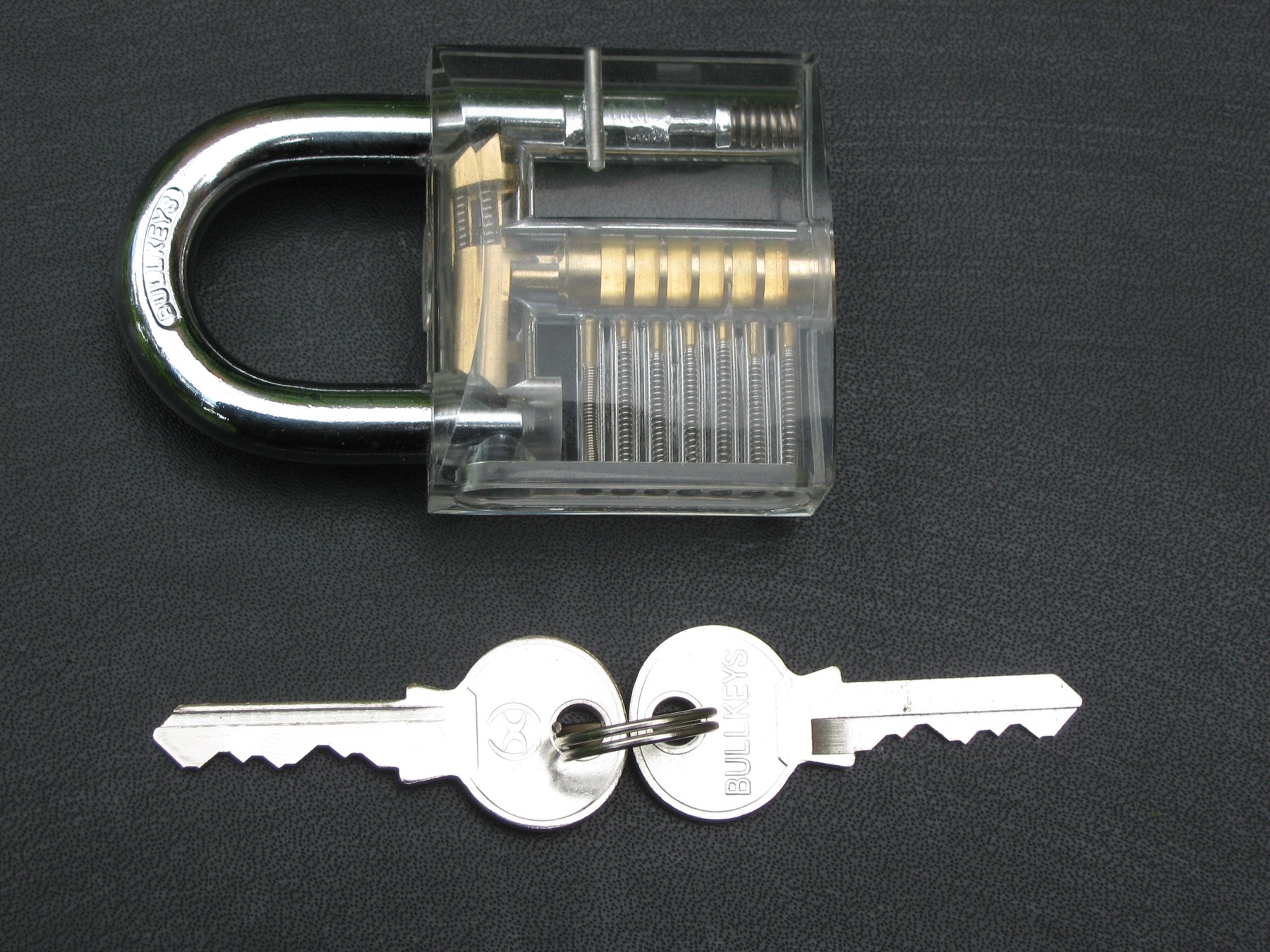Transparent padlock and keys showing lock components
